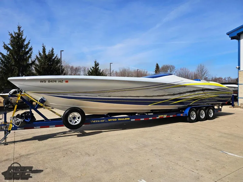 Slide: The Image of 2007 Outerlimits 39 Quattro speedboat on trailer, sleek design with vibrant graphics. - 13