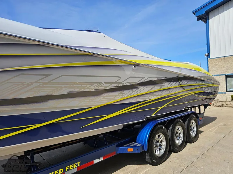Slide: The Image of 2007 Outerlimits 39 Quattro boat on trailer, featuring sleek design and vibrant graphics. - 16