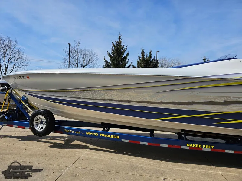 Slide: The Image of 2007 Outerlimits 39 Quattro boat on trailer, sleek design with blue and yellow accents. - 17