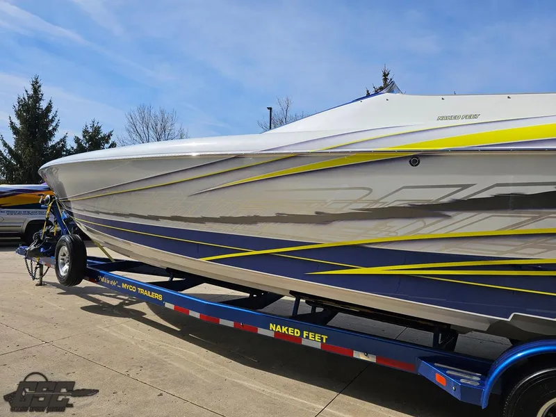Slide: The Image of 2007 Outerlimits 39 Quattro speedboat on trailer, featuring sleek blue and yellow design. - 18