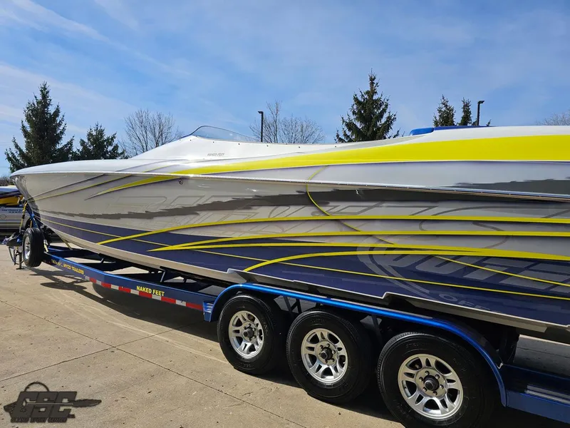 Slide: The Image of 2007 Outerlimits 39 Quattro speedboat with vibrant graphics on a trailer. - 19