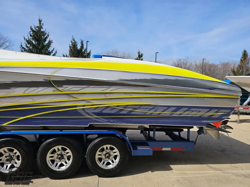 Slide: The Image of 2007 Outerlimits 39 Quattro boat on trailer, featuring sleek design and vibrant yellow accents. - 20