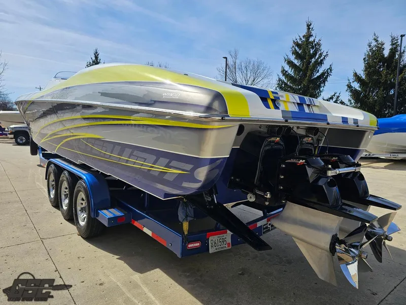 Slide: The Image of 2007 Outerlimits 39 Quattro speedboat on trailer, featuring sleek design and vibrant graphics. - 23