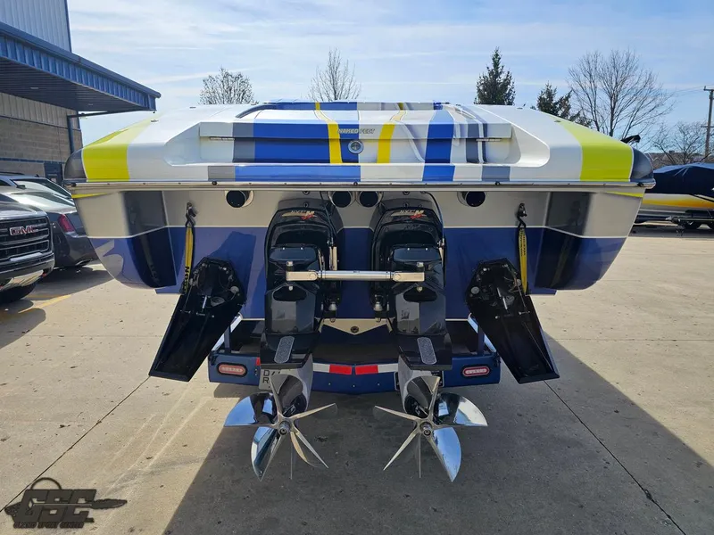 Slide: The Image of 2007 Outerlimits 39 Quattro boat with dual engines and vibrant blue-yellow design. - 24
