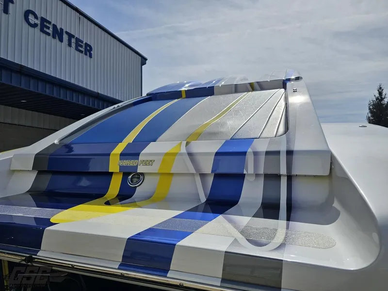 Slide: The Image of 2007 Outerlimits 39 Quattro boat with vibrant blue, yellow, and white stripes. - 29