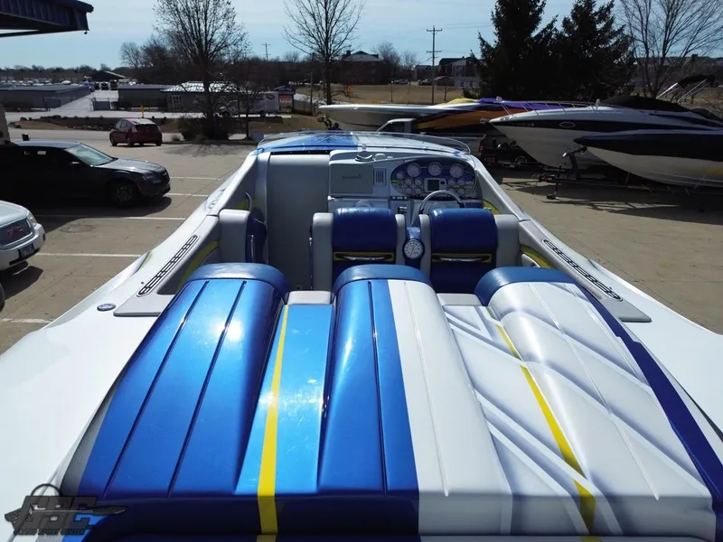 Slide: The Image of 2007 Outerlimits 39 Quattro boat with blue and white seating, docked outdoors. - 31