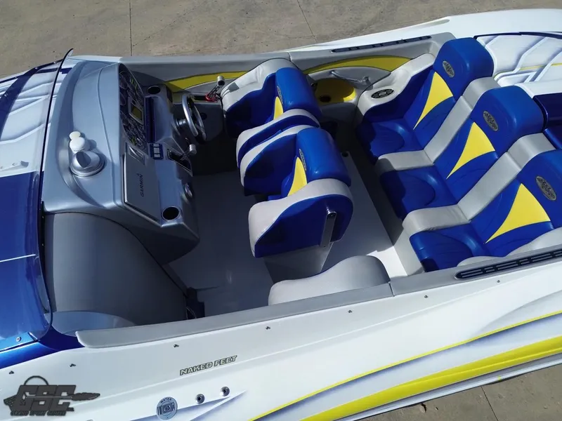 Slide: The Image of 2007 Outerlimits 39 Quattro boat interior with blue and yellow seating, sleek dashboard design. - 34