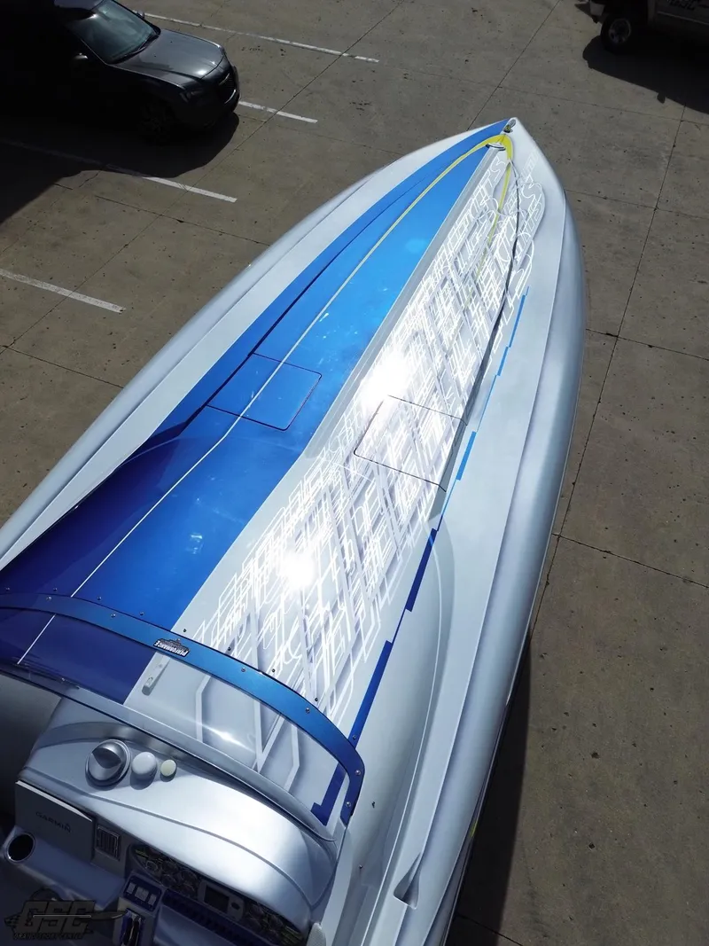 Slide: The Image of 2007 Outerlimits 39 Quattro boat with sleek blue and white design, viewed from above. - 38