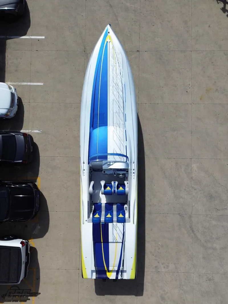 Slide: The Image of 2007 Outerlimits 39 Quattro speedboat with blue and white design, parked in a lot. - 39