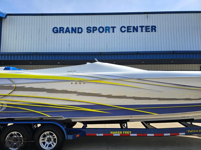 Slide: The Image of 2007 Outerlimits 39 Quattro boat at Grand Sport Center, vibrant design on trailer. - 4