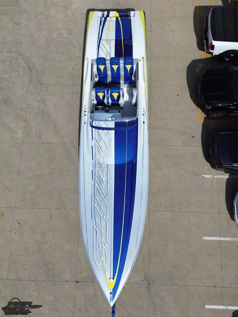 Slide: The Image of 2007 Outerlimits 39 Quattro speedboat with blue and white design, parked in a lot. - 42
