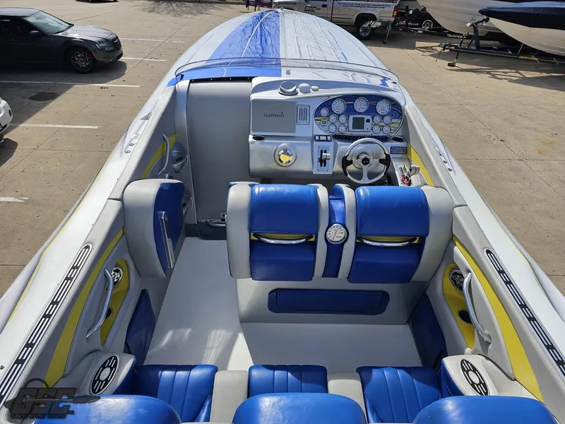 Slide: The Image of 2007 Outerlimits 39 Quattro boat interior with blue and yellow seating, detailed dashboard. - 49