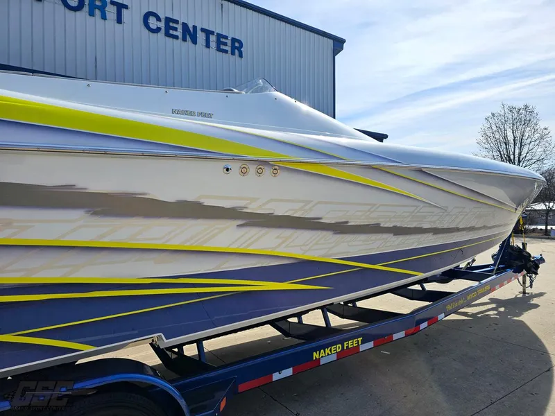 Slide: The Image of 2007 Outerlimits 39 Quattro speedboat on trailer, featuring sleek design and vibrant graphics. - 8