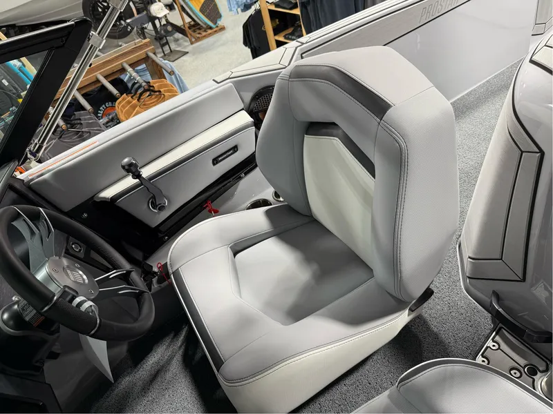 Slide: The Image of 2025 MasterCraft ProStar interior with sleek gray seating and modern dashboard design. - 17