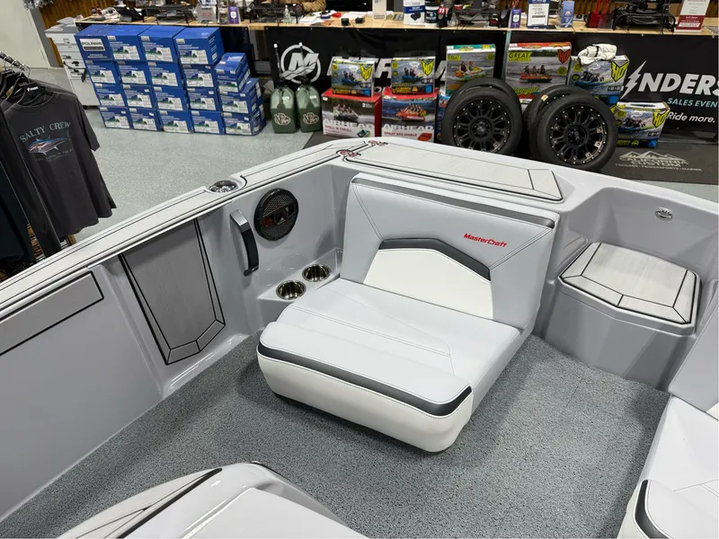 Slide: The Image of 2025 MasterCraft ProStar boat interior with white seating and storage compartments. - 22