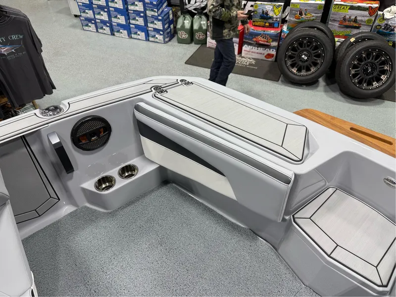 Slide: The Image of 2025 MasterCraft ProStar boat interior with seating and speaker system in showroom. - 23