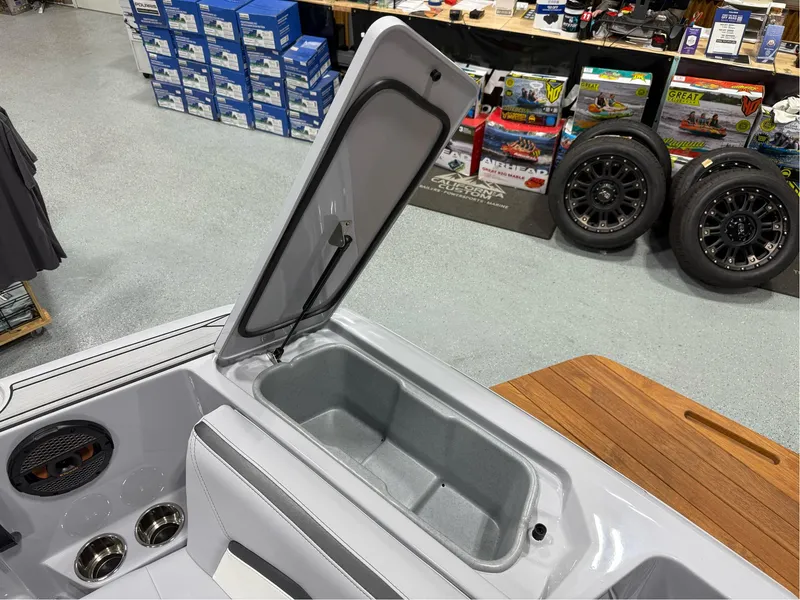 Slide: The Image of 2025 MasterCraft ProStar boat storage compartment open in showroom. - 31