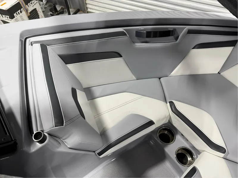 Slide: The Image of 2025 MasterCraft ProStar interior with sleek gray and white seating and cup holders. - 34