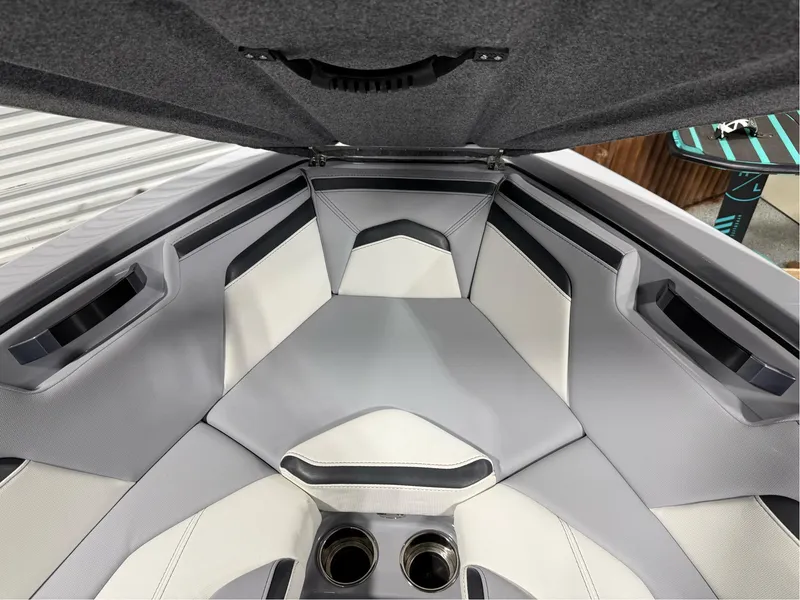 Slide: The Image of 2025 MasterCraft ProStar interior with gray and white seating, featuring cup holders. - 35