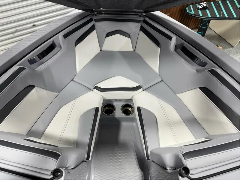 Slide: The Image of 2025 MasterCraft ProStar interior with gray and white seating, featuring cup holders. - 37