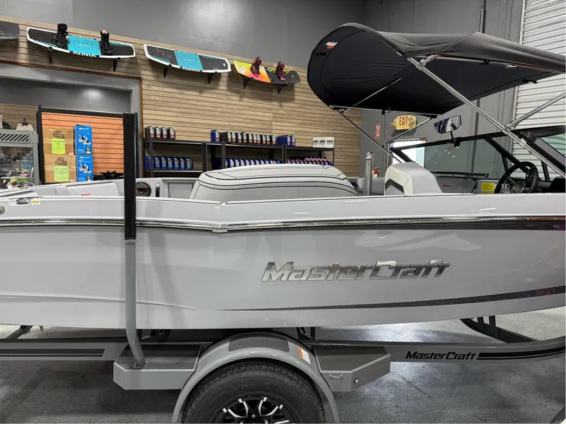 Slide: The Image of 2025 MasterCraft ProStar boat in showroom, side view with trailer and accessories. - 6