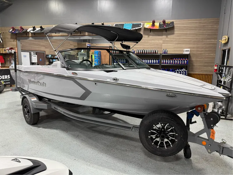 Slide: The Image of 2025 MasterCraft ProStar boat in showroom, sleek design, gray color, on trailer. - 7
