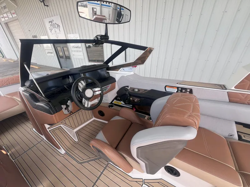 Slide: The Image of 2022 Nautique Super Air Nautique G25 Paragon interior with luxury seating and modern dashboard. - 11