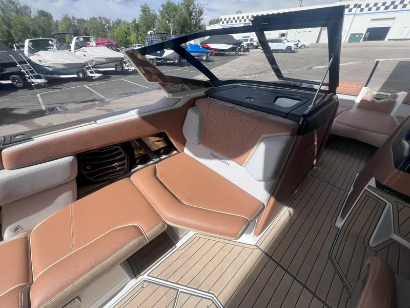 Slide: The Image of 2022 Nautique Super Air Nautique G25 Paragon interior with tan seating and sleek design. - 12