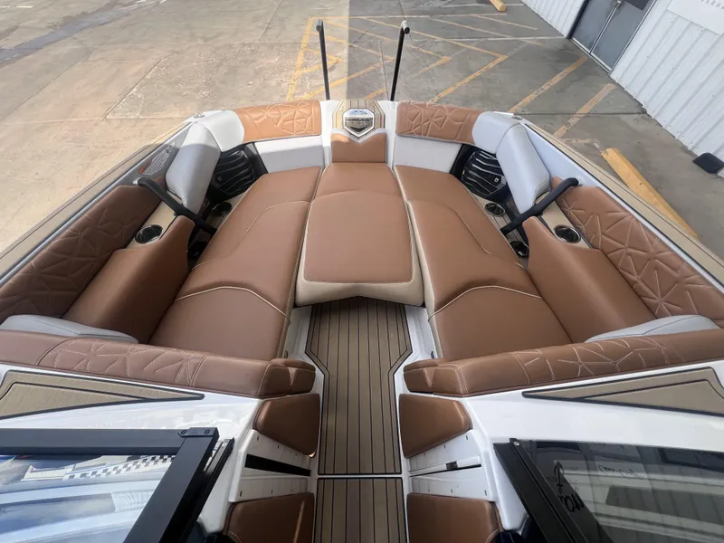 Slide: The Image of 2022 Nautique Super Air Nautique G25 Paragon interior with luxurious brown seating. - 13
