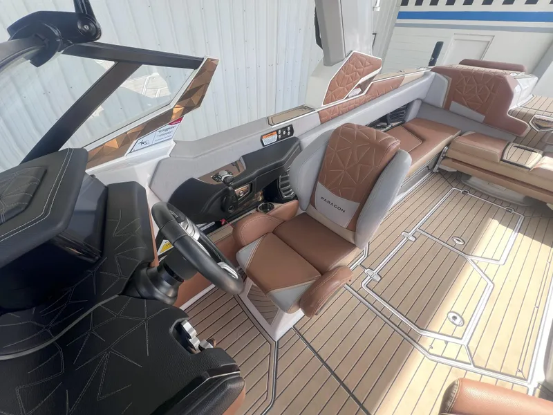 Slide: The Image of 2022 Nautique Super Air Nautique G25 Paragon interior with luxurious seating and modern dashboard. - 15
