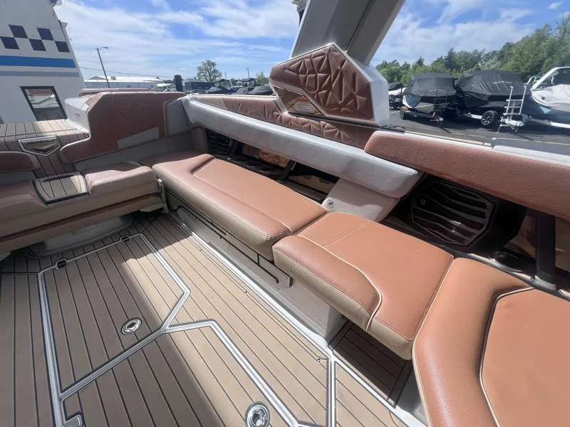 Slide: The Image of Luxurious interior of 2022 Nautique Super Air Nautique G25 Paragon boat with tan seating. - 16