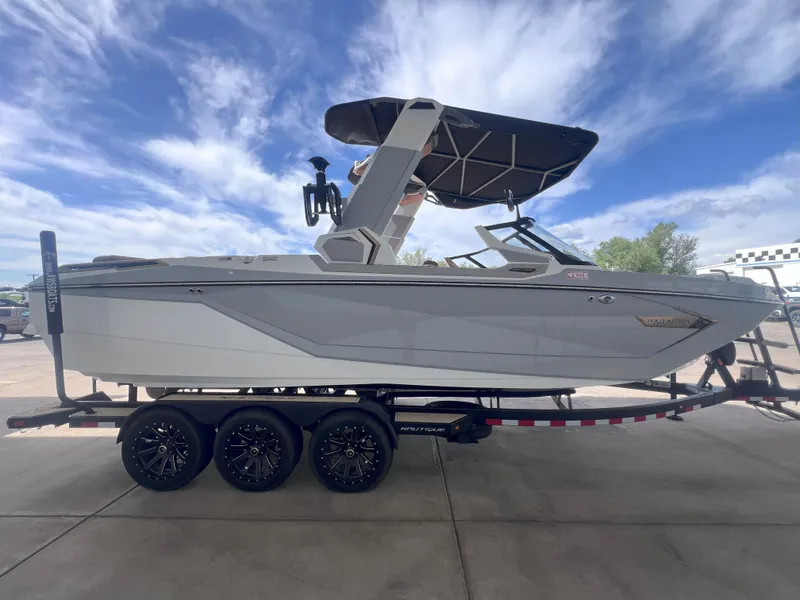 Slide: The Image of 2022 Nautique Super Air Nautique G25 Paragon boat on trailer under blue sky. - 5