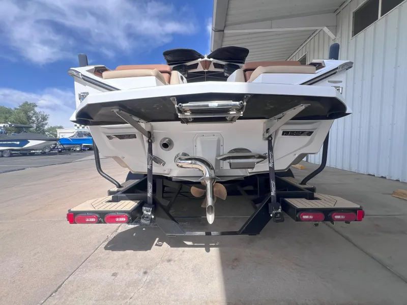 Slide: The Image of 2022 Nautique Super Air Nautique G25 Paragon boat rear view at dock. - 7