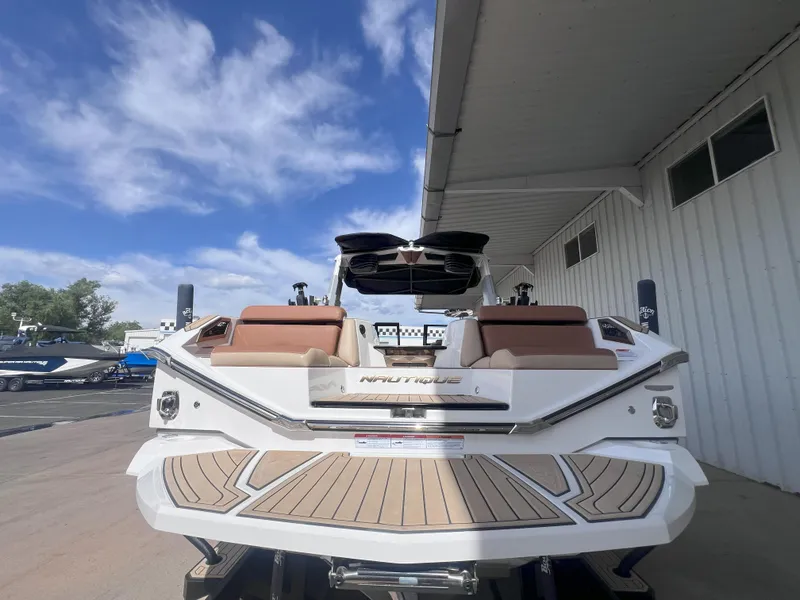 Slide: The Image of 2022 Nautique Super Air Nautique G25 Paragon boat, rear view, under blue sky. - 8
