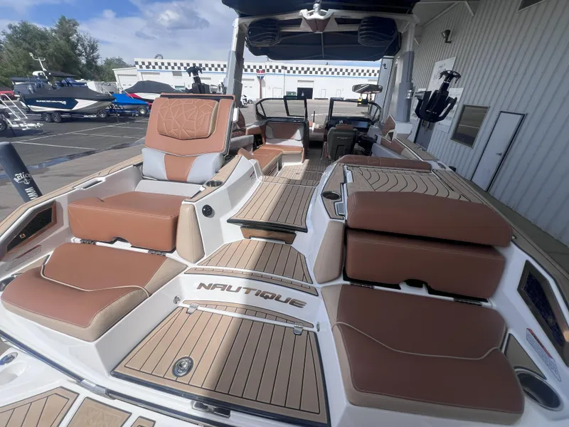 Slide: The Image of 2022 Nautique Super Air Nautique G25 Paragon boat with luxurious seating and deck design. - 9