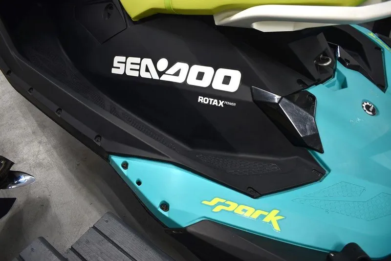 Slide: The Image of 2022 Sea-Doo Spark 3-up Rotax 900 ACE, turquoise and black design, close-up view. - 18