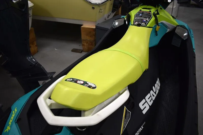 Slide: The Image of 2022 Sea-Doo Spark® 3-up Rotax® 900 ACE™ with Audio, lime green seat, in showroom. - 24