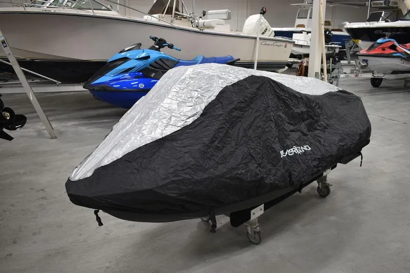 Slide: The Image of 2022 Sea-Doo Spark 3-up jet ski covered in a protective tarp in a showroom. - 36