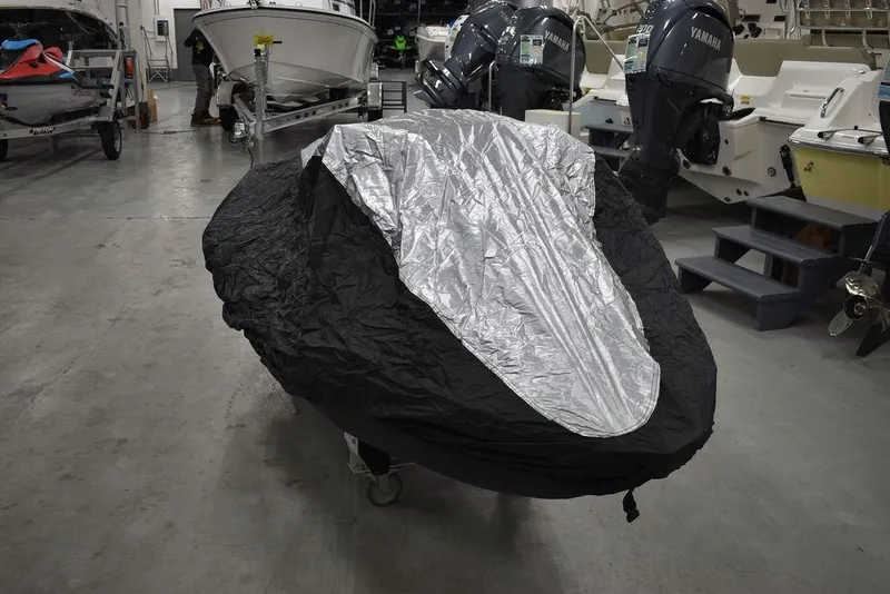 Slide: The Image of 2022 Sea-Doo Spark® 3-up covered in a garage with boats and engines. - 38