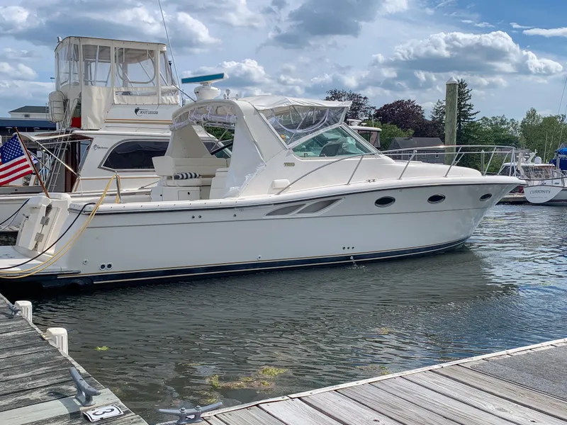 Slide: The Image of 1998 Tiara Yachts 3500 Open docked at marina under cloudy sky. - 0