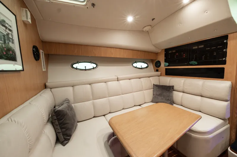 Slide: The Image of 1998 Tiara Yachts 3500 Open interior with plush seating and wooden table. - 15