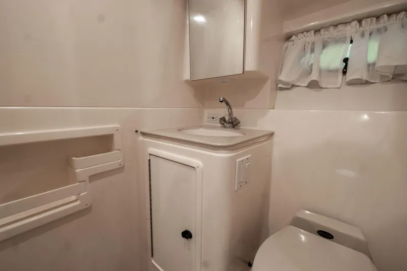 Slide: The Image of 1998 Tiara Yachts 3500 Open bathroom with sink, mirror, and toilet. - 17
