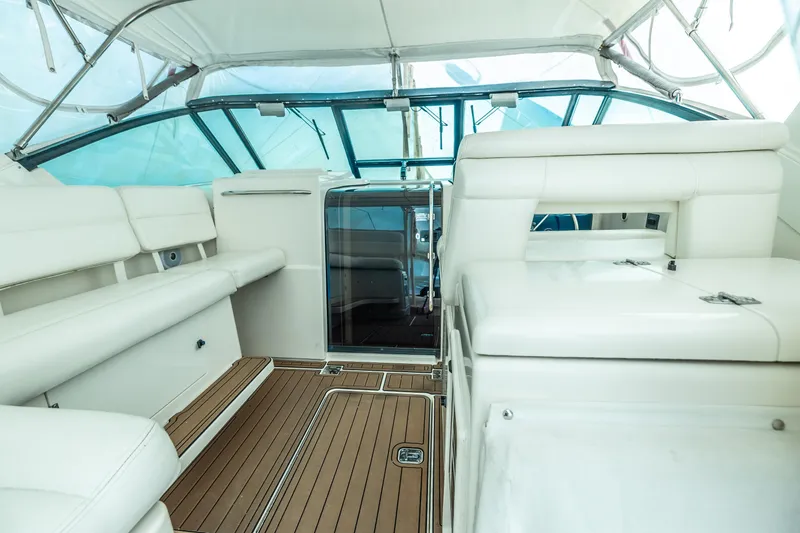 Slide: The Image of 1998 Tiara Yachts 3500 Open interior with white seating and wooden flooring. - 4