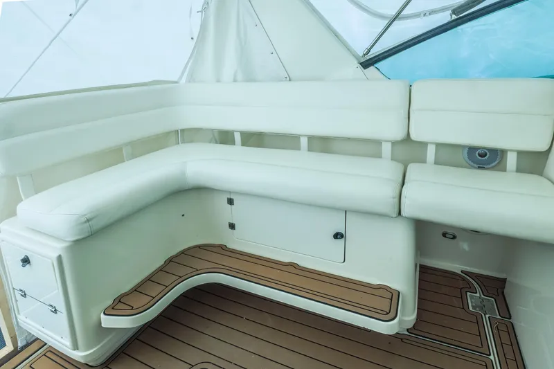 Slide: The Image of 1998 Tiara Yachts 3500 Open interior with white seating and wooden flooring. - 5