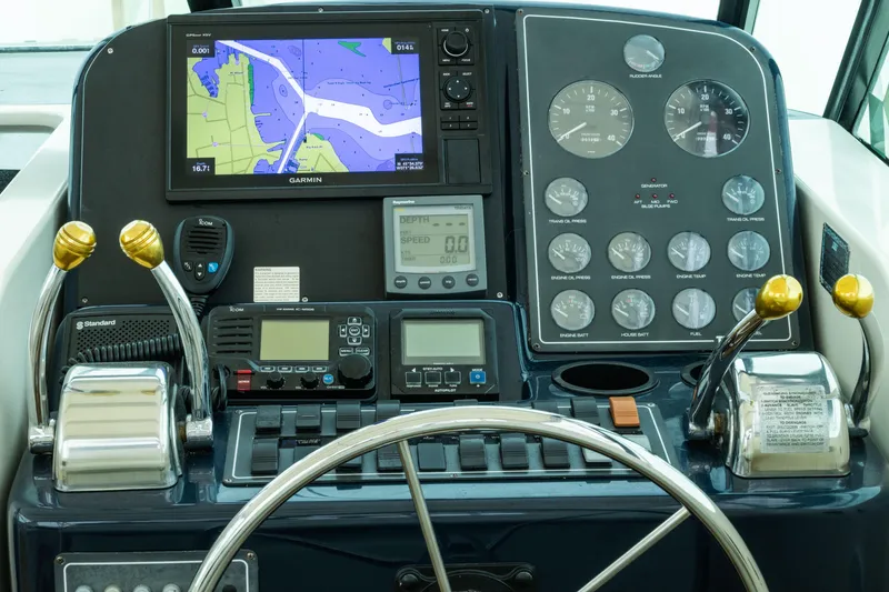 Slide: The Image of Cockpit of 1998 Tiara Yachts 3500 Open with navigation and control instruments. - 9
