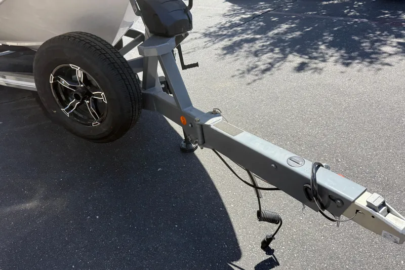 Slide: The Image of Trailer hitch of 2025 MasterCraft XT24 boat on asphalt surface. - 11