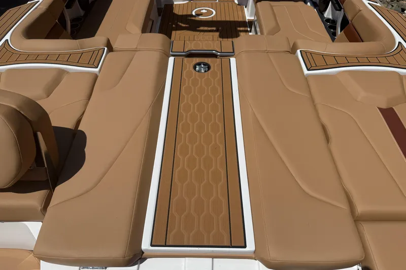 Slide: The Image of 2025 MasterCraft XT24 boat interior with tan upholstery and sleek design. - 17