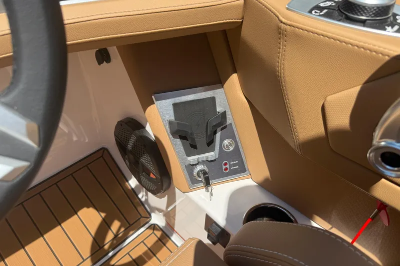Slide: The Image of 2025 MasterCraft XT24 boat interior with tan upholstery and control panel. - 20