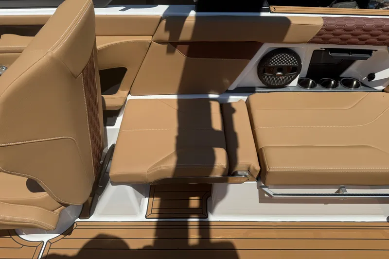 Slide: The Image of 2025 MasterCraft XT24 boat interior with tan leather seats and modern design features. - 22