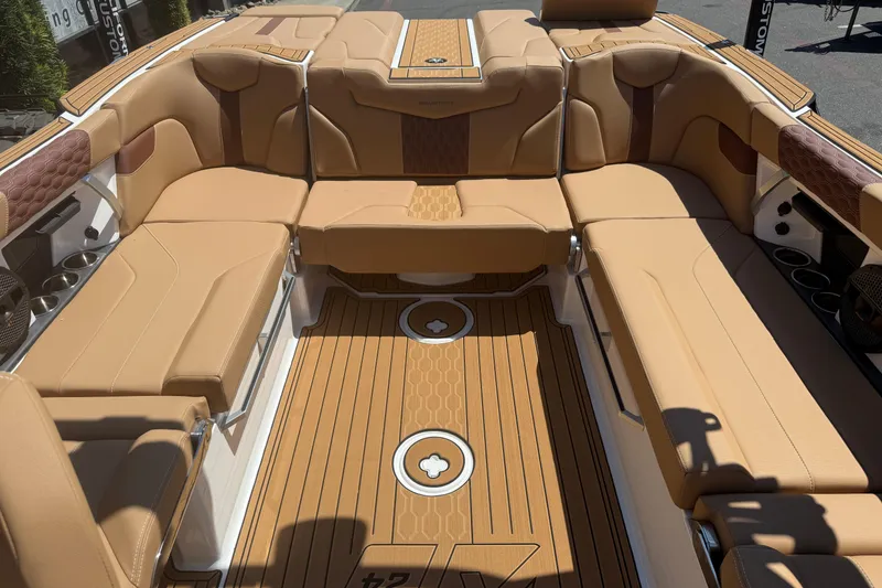 Slide: The Image of Luxurious interior of 2025 MasterCraft XT24 boat with tan leather seating and wood flooring. - 25